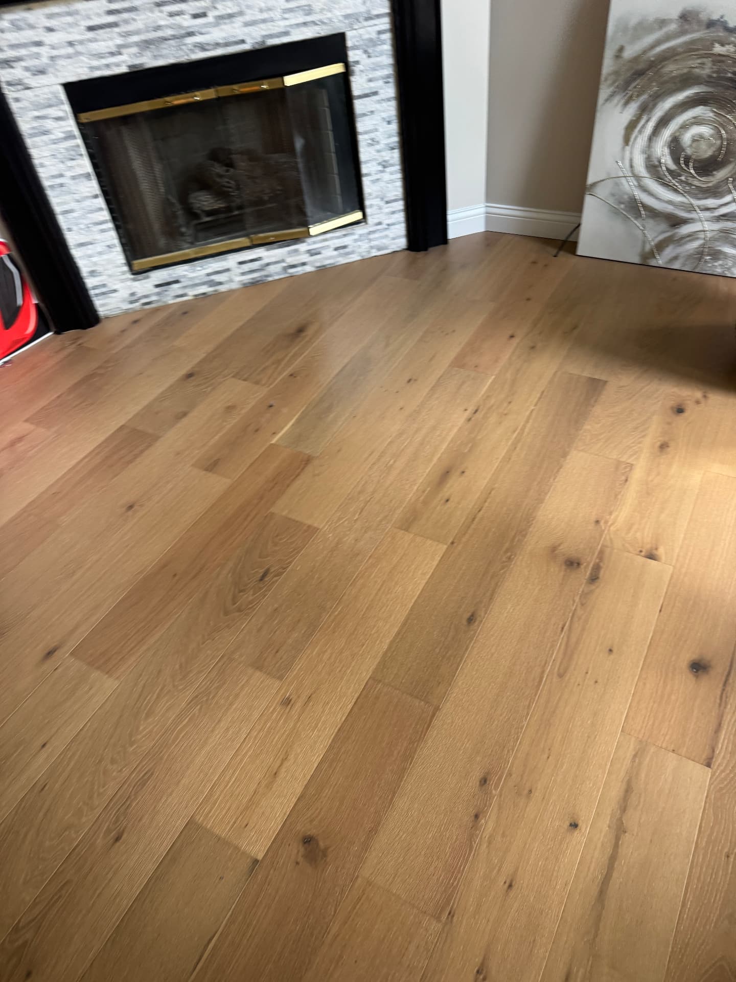 Matching engineered waterproof wood flooring at the fireplace