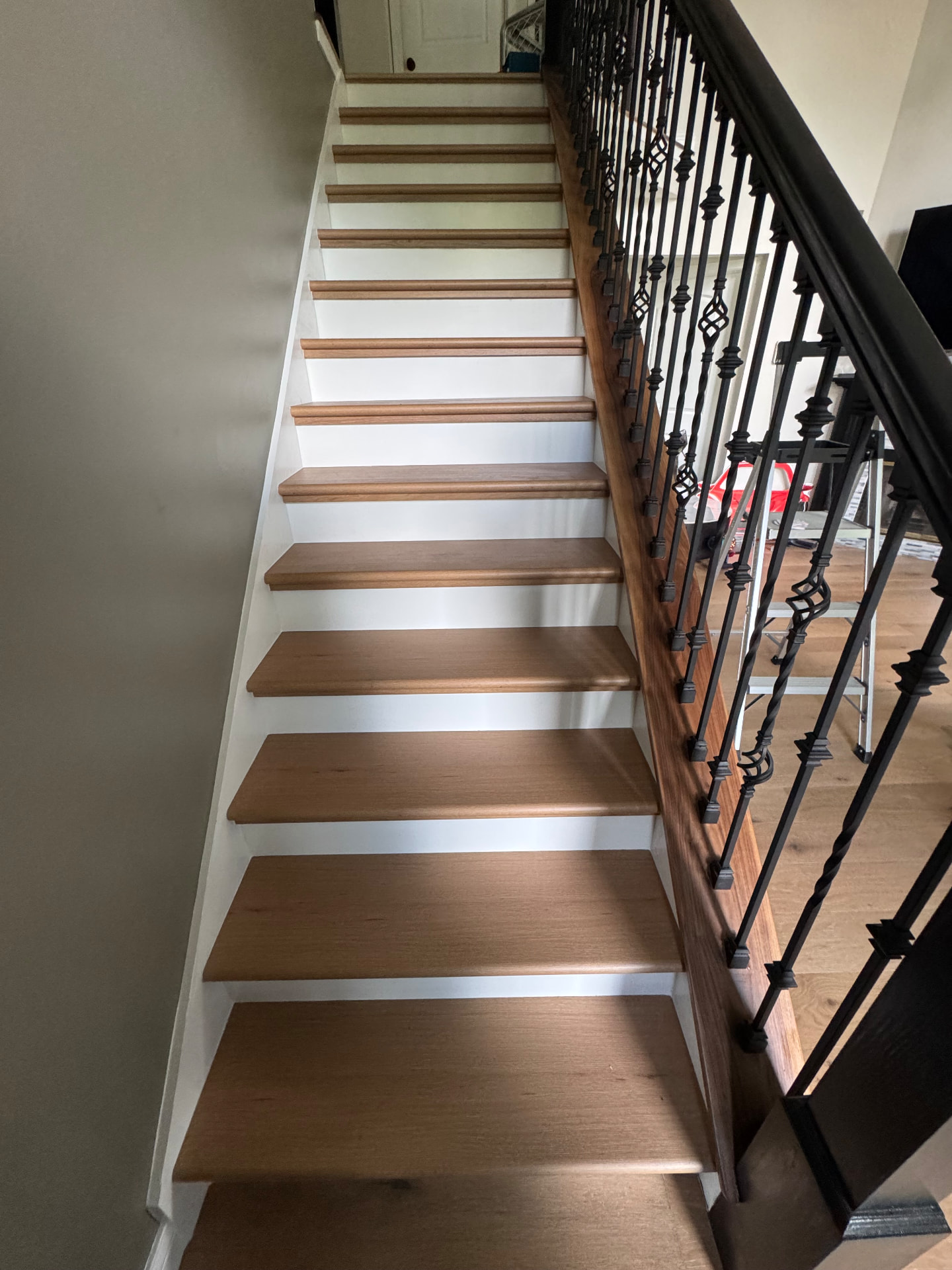New wrought-iron balusters and hardwood-capped handrail