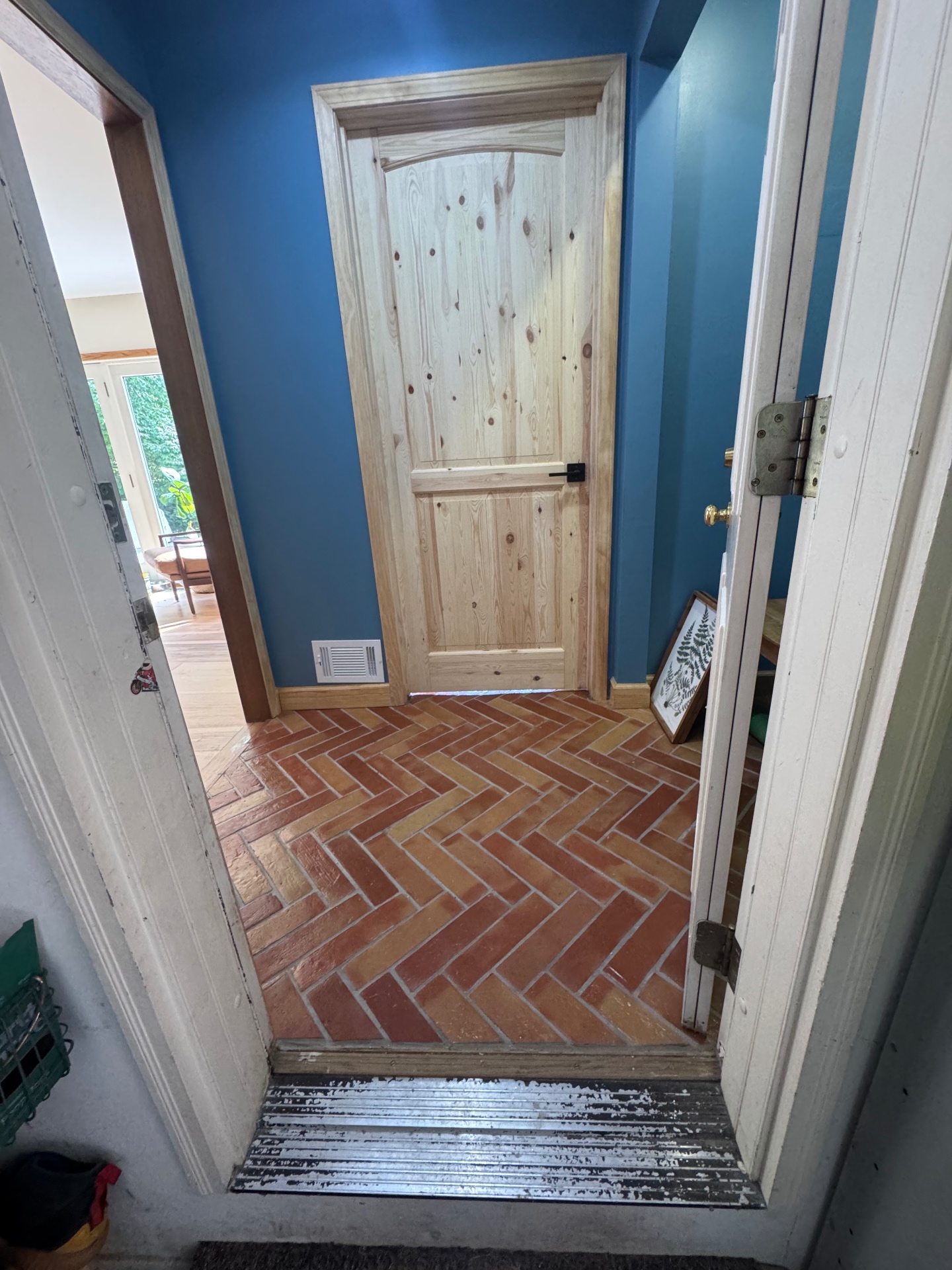Herringbone brick-tile entryway